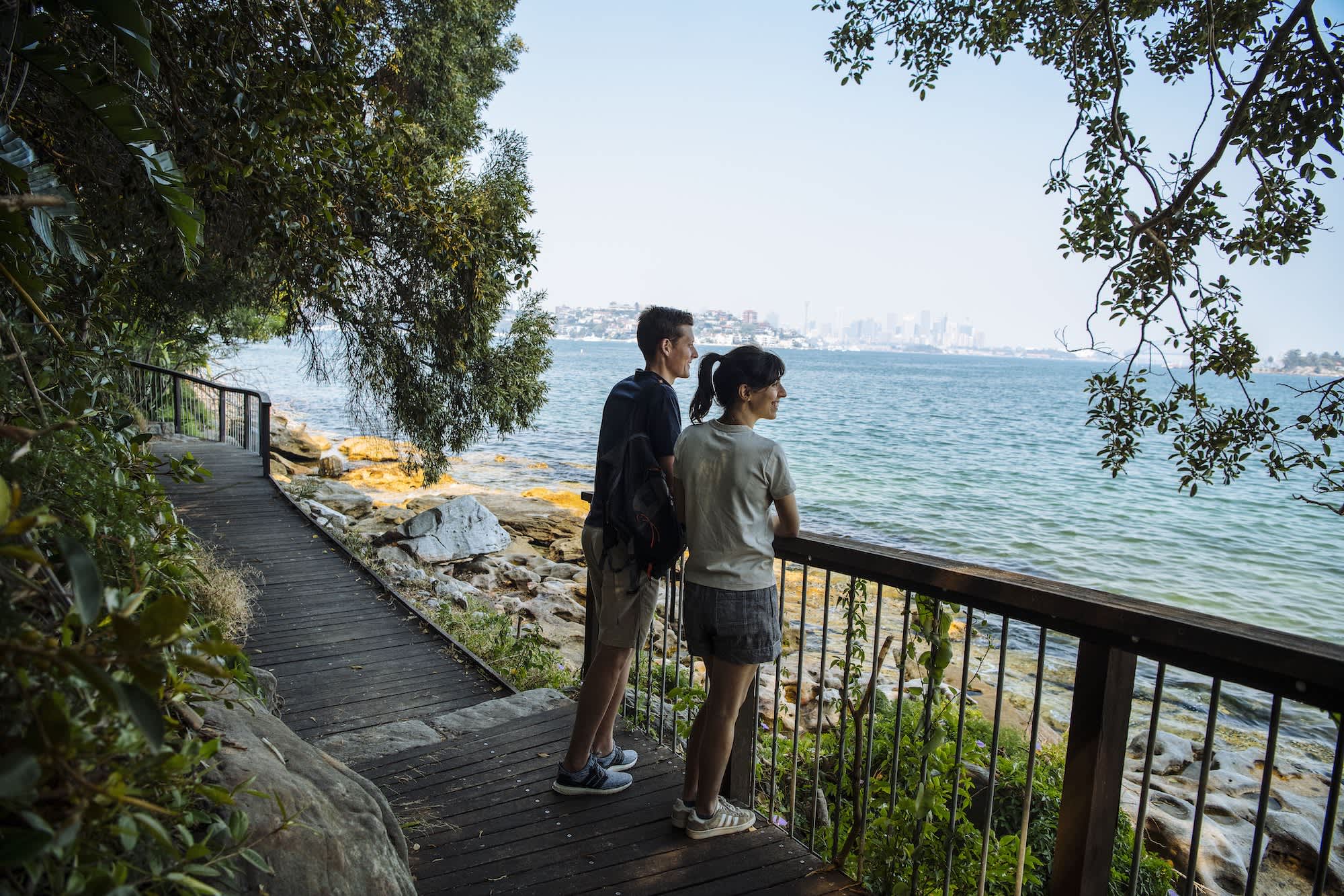 Couple enjoying scenic views across Sydney Harbour along the Hermitage Foreshore Walk, Vaucluse.