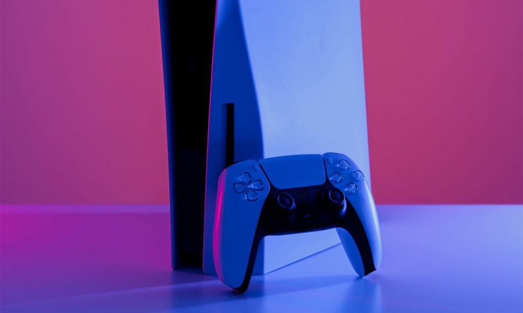 PS5 console and wireless controller against a purple background.