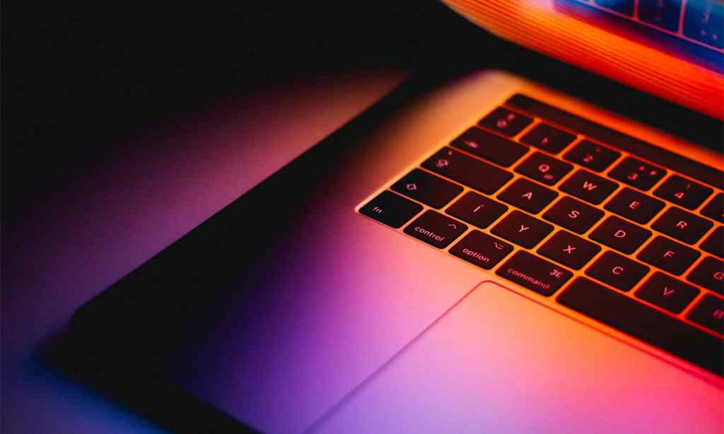 Close up of a Mac Book keyboard and trackpad.