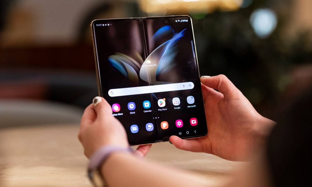 Close-up of a woman's hands holding the Samsung Galaxy Z Fold4.