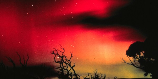 An image of glowing red skies showcasing the southern lights in Tasmania.