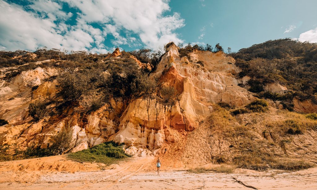 A view of the cliffs of Rainbow Beach to detail the accommodation options.