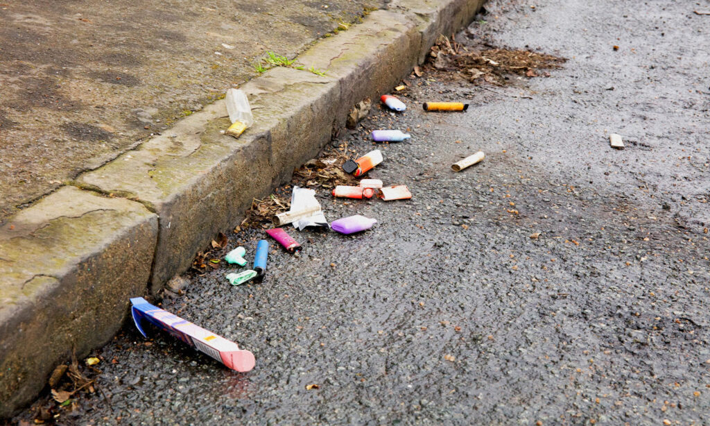 An image showing vape waste on the street to illustrate how to dispose of a vape properly