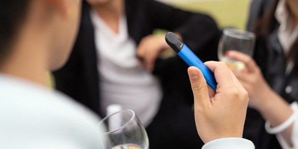 An image showing a man vaping to illustrate the cost of pharmacy vapes in Australia