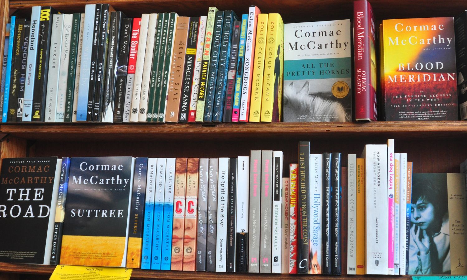 A bookshelf showing Cormac McCarthy books.