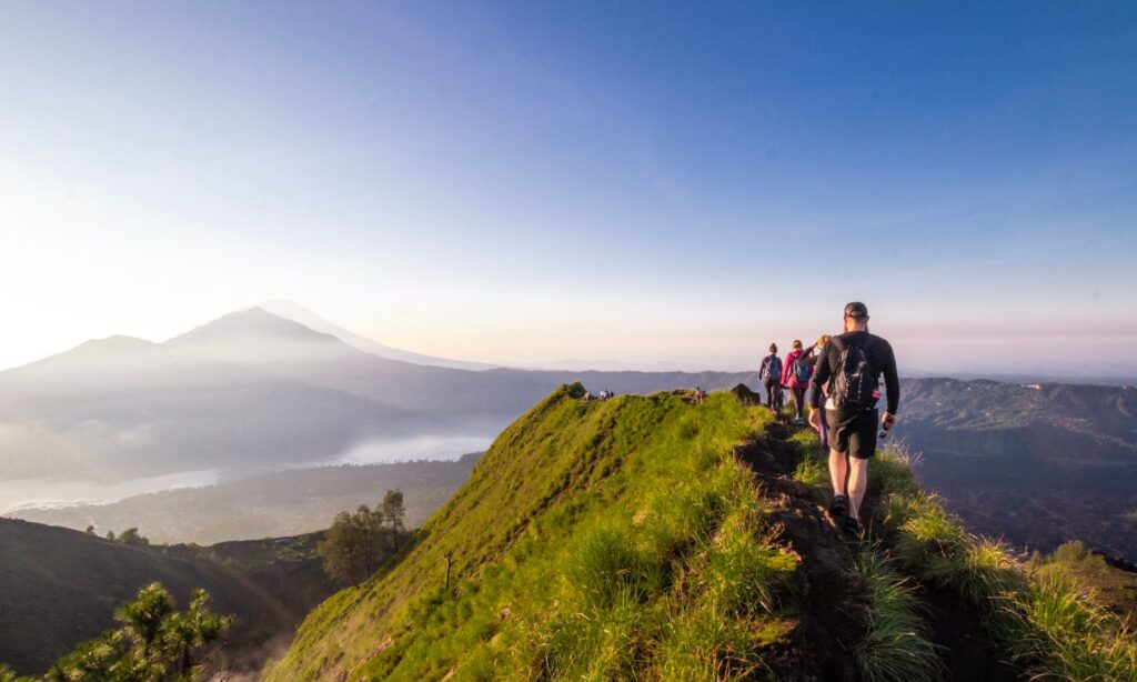 An image showing tourists climbling a mountan in Bali, one of several activies banned under new laws.