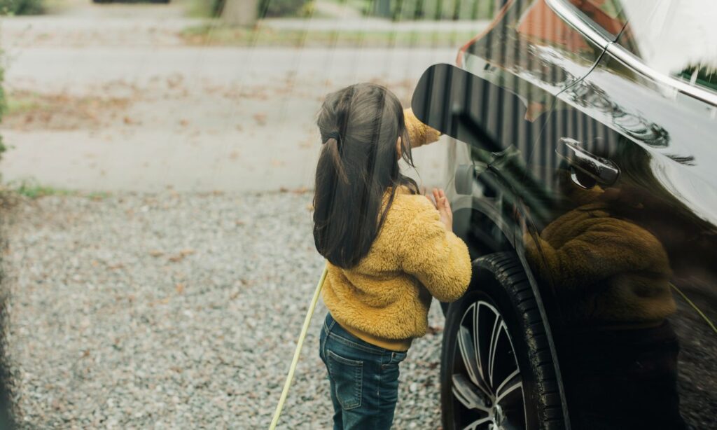 An image showing a girl charging an EV in Australia at home.