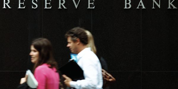 An image showing people walking past the Reserve Bank of Australia, the place that sets the cash and interest rates.