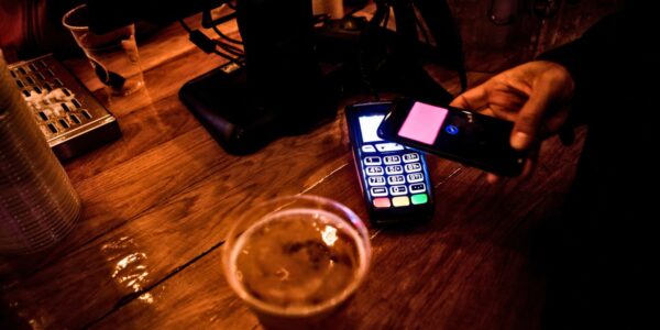 An image showing someone paying for beer.