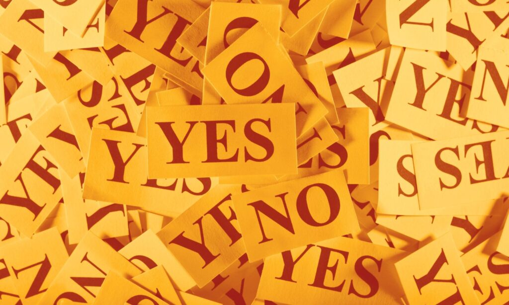 Image of papers with the words yes and no on them to illustrate an article about the indigenous voice to parliament vote