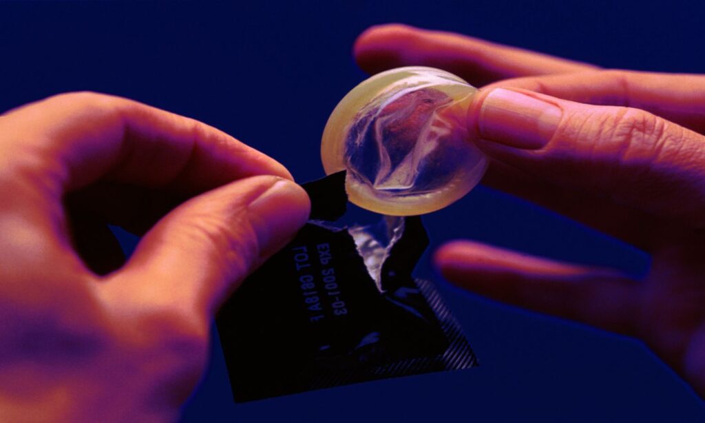 An image of a condom being opened which is integral to the act of stealthing in queensland.