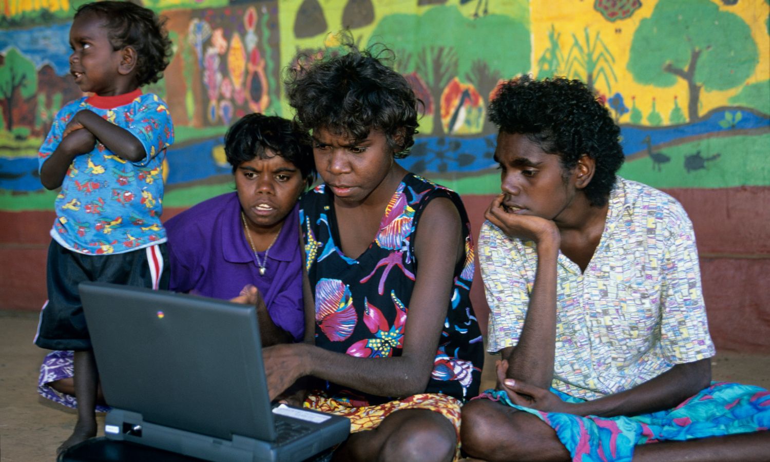 An image showing Indigenous women using a laptop in Arnhem Land 