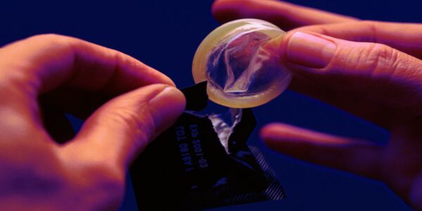 An image of a condom being opened which is integral to the act of stealthing in queensland.